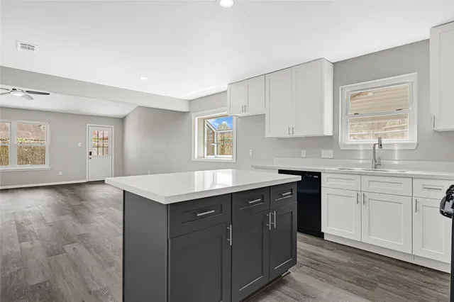 a kitchen with a sink cabinets and window