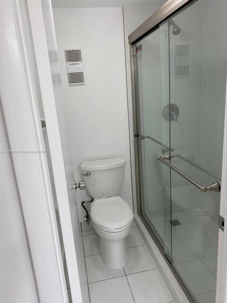 6320 Southwest 138th Court, Unit 308 Miami, FL 33183 - Photo 11 of 25 a white toilet sitting next to a shower