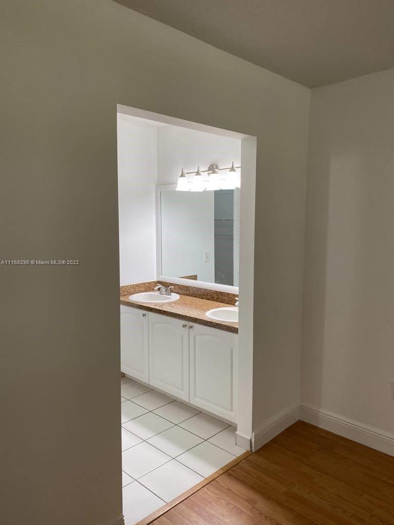 6320 Southwest 138th Court, Unit 308 Miami, FL 33183 - Photo 14 of 25 a spacious bathroom with a sink and a mirror