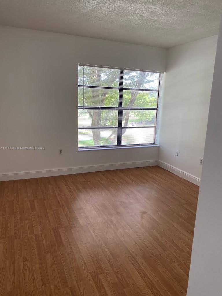 6320 Southwest 138th Court, Unit 308 Miami, FL 33183 - Photo 2 of 25 an empty room with a window