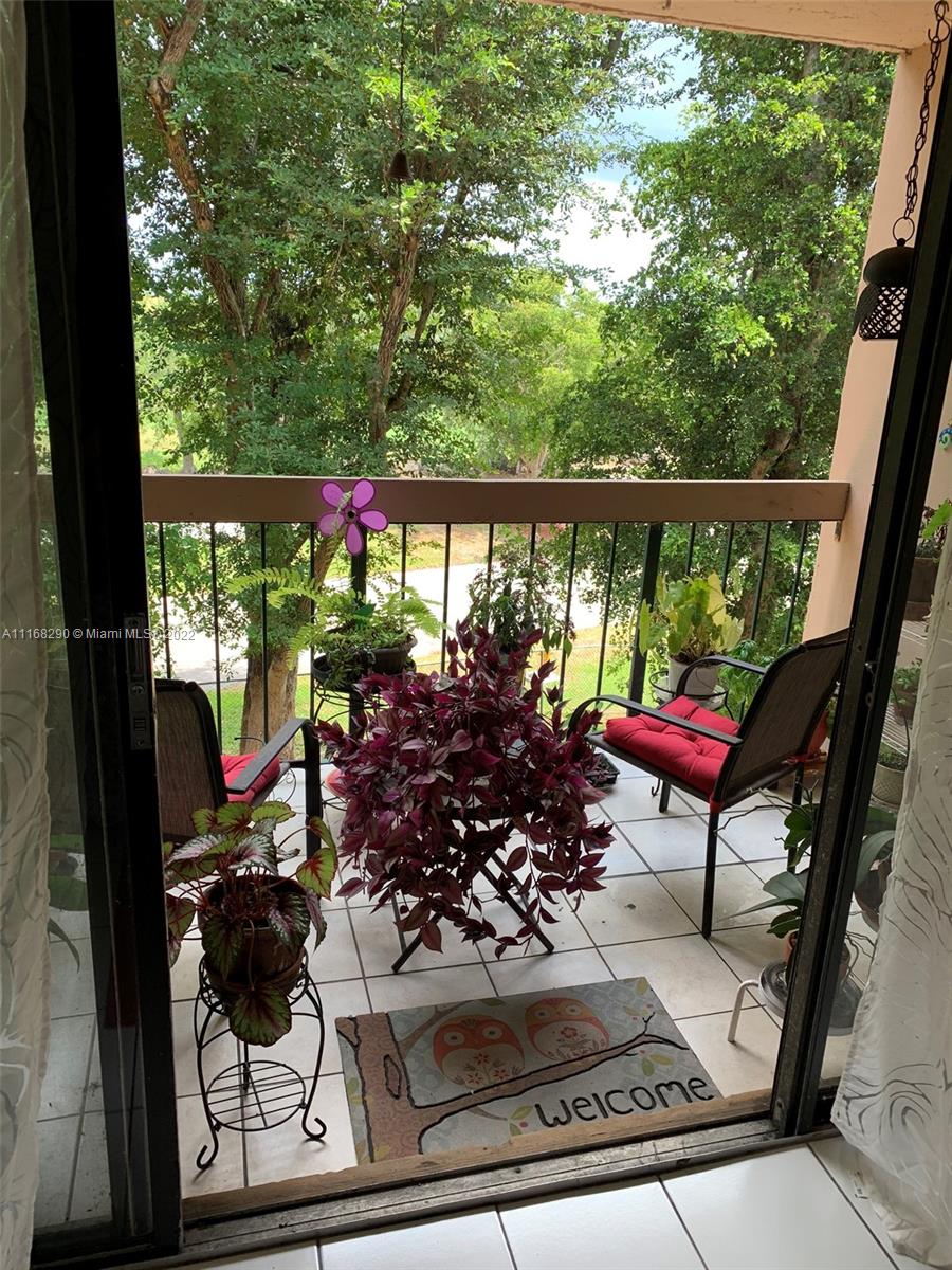6320 Southwest 138th Court, Unit 308 Miami, FL 33183 - Photo 24 of 25 a view of a balcony with chairs potted plants