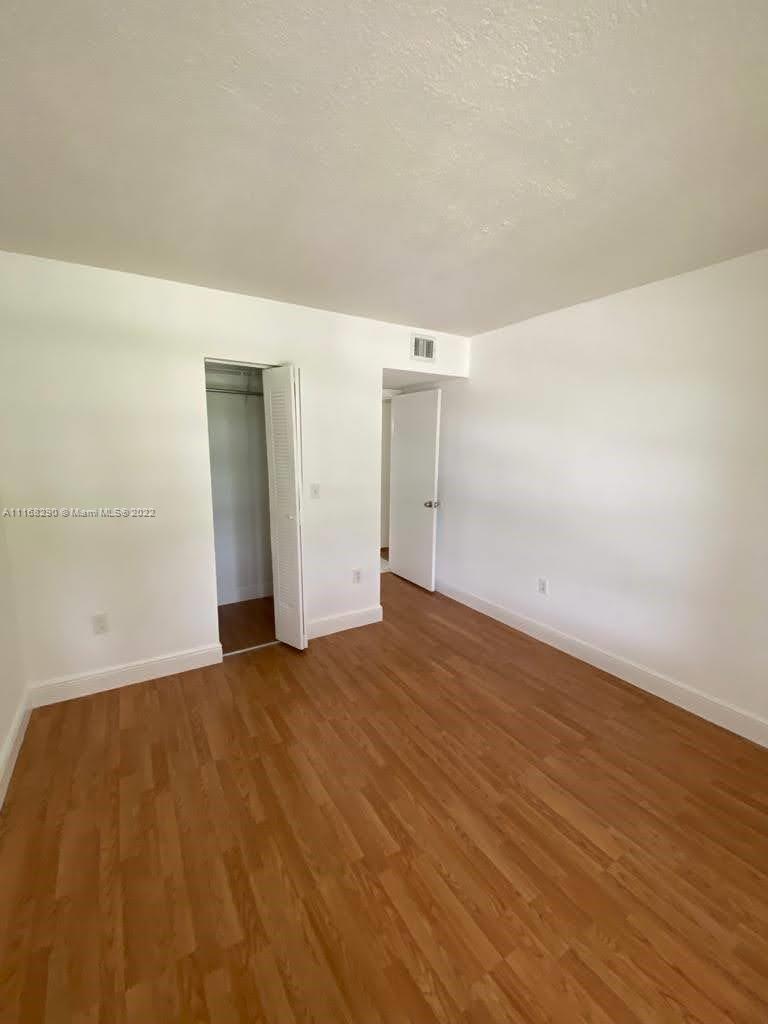 6320 Southwest 138th Court, Unit 308 Miami, FL 33183 - Photo 3 of 25 a view of empty room with wooden floor