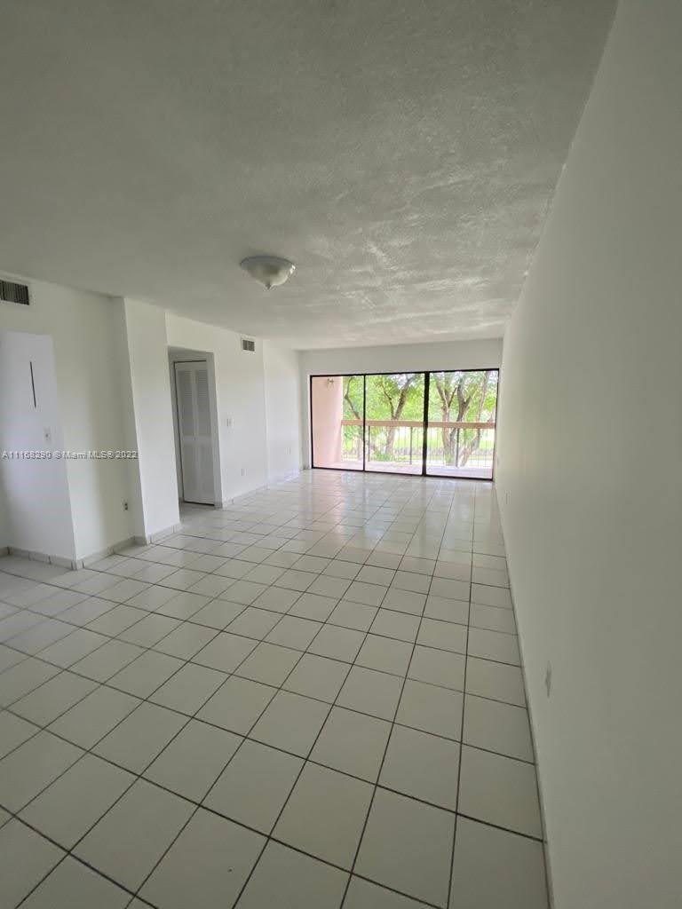 6320 Southwest 138th Court, Unit 308 Miami, FL 33183 - Photo 8 of 25 an empty room with windows