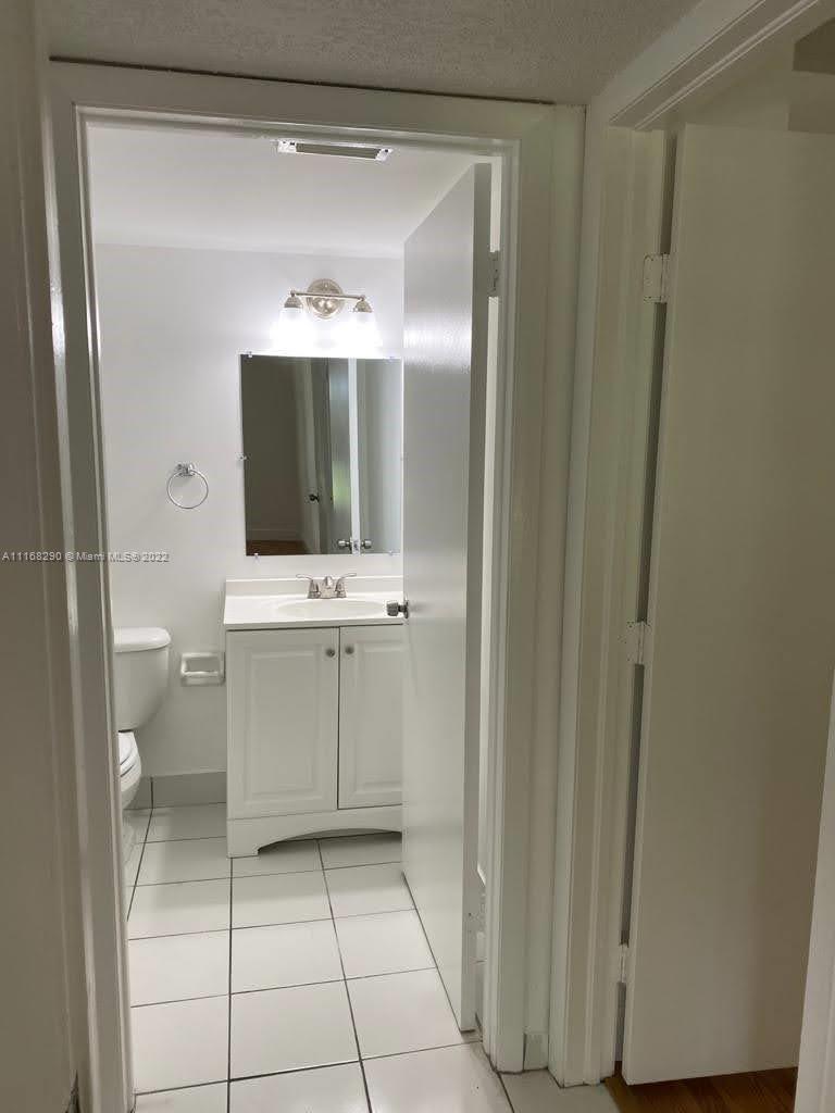 6320 Southwest 138th Court, Unit 308 Miami, FL 33183 - Photo 9 of 25 a bathroom with a sink a toilet and shower