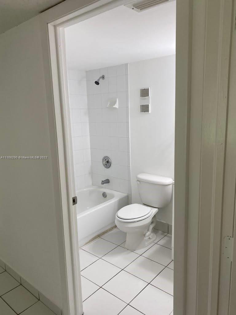 6320 Southwest 138th Court, Unit 308 Miami, FL 33183 - Photo 10 of 25 a bathroom with a toilet a sink and shower