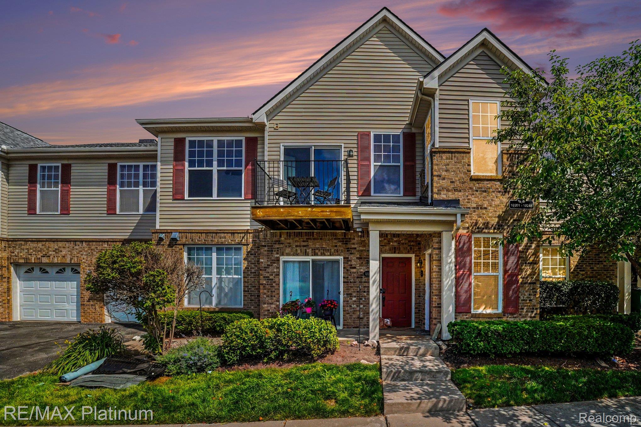 10217 Crossview Trail Howell, MI 48855 - Photo 1 of 26 Multi-story residence featuring a brick and siding exterior with a red front door