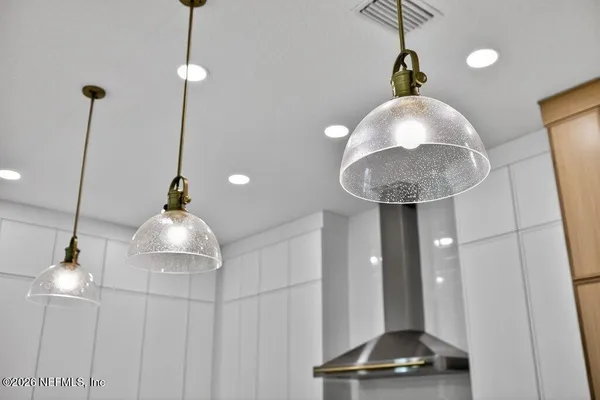 a spacious bathroom with a sink a large mirror and a shower