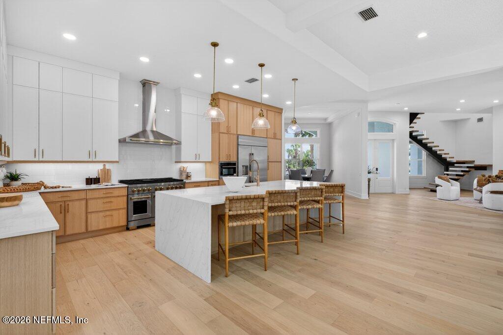 6 Riviera Place Palm Coast, FL 32137 - Photo 18 of 132 a kitchen with a table chairs wooden floors and a view of living room