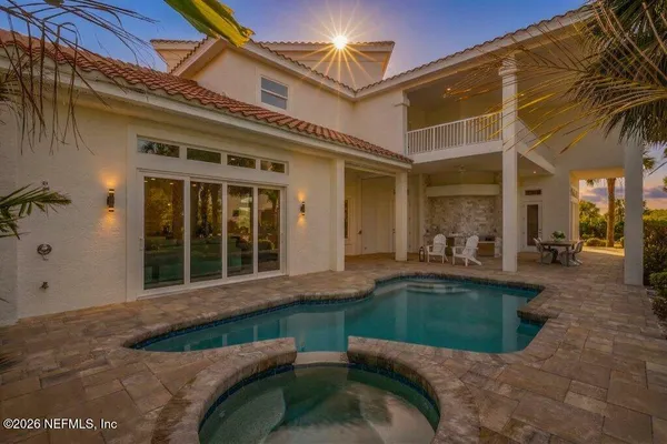 a kitchen with stainless steel appliances granite countertop a refrigerator a stove and a sink