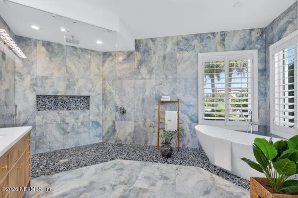 a bathroom with a bathtub and a sink