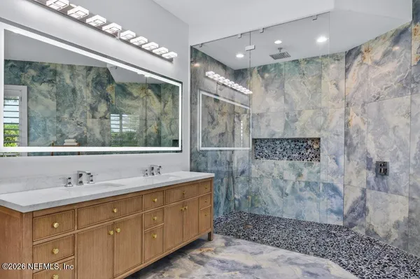 a spacious bathroom with a double vanity sink and a mirror