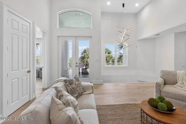 a media room with lots of chairs and a chandelier