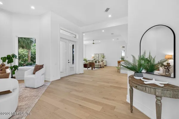 a kitchen with a dining table chairs stainless steel appliances and cabinets