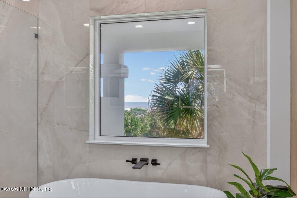 6 Riviera Place Palm Coast, FL 32137 - Photo 78 of 132 a bathroom with a bathtub and a shower