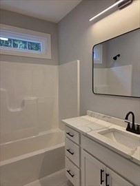 149 Bragg Hill Road Westminster, MA 01473 - Photo 12 of 17 a bathroom with a granite countertop sink a mirror and a bathtub