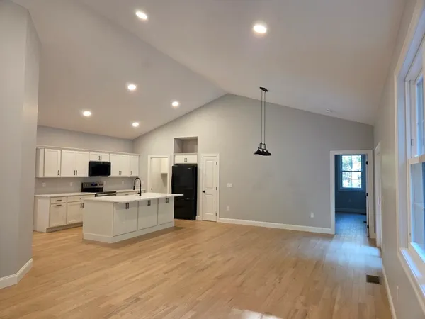 a view of kitchen with wooden floor and electronic appliances