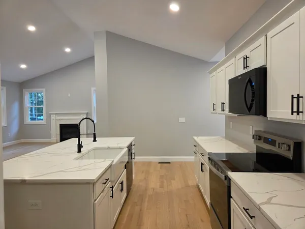 a kitchen with a sink stove and microwave