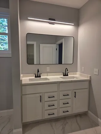 a bathroom with a double vanity sink and mirror