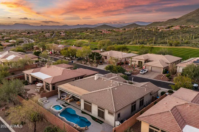 a front view of a house with a yard and a garden