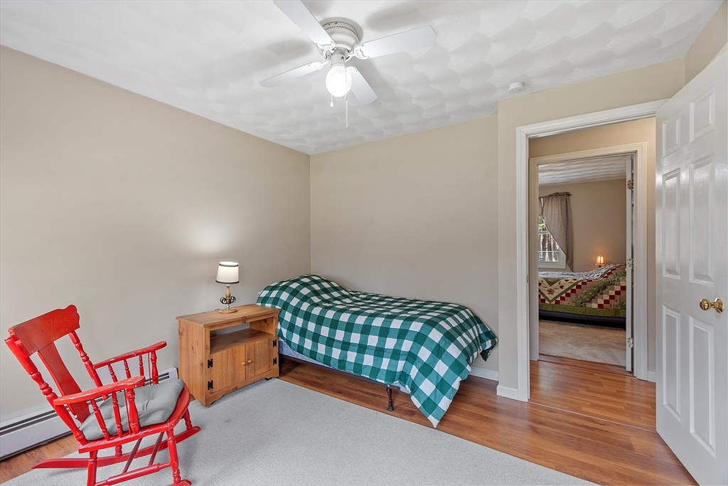 717 Old Petersham Road Barre, MA 01005 - Photo 20 of 40 a bedroom with furniture and a chandelier