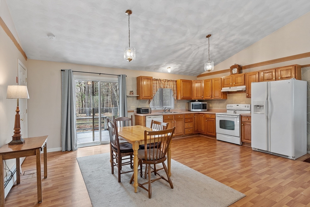 717 Old Petersham Road Barre, MA 01005 - Photo 2 of 40 a kitchen with stainless steel appliances granite countertop a stove a refrigerator a oven a sink with a dining table and chairs