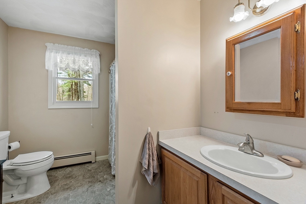 717 Old Petersham Road Barre, MA 01005 - Photo 27 of 40 a bathroom with a granite countertop sink toilet and mirror