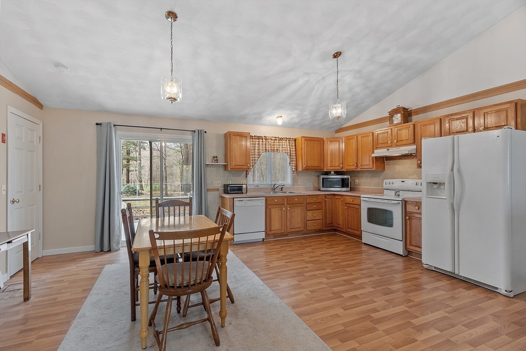 717 Old Petersham Road Barre, MA 01005 - Photo 4 of 40 a kitchen with refrigerator a sink and chairs