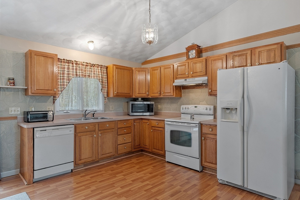 717 Old Petersham Road Barre, MA 01005 - Photo 5 of 40 a kitchen with stainless steel appliances granite countertop a stove a sink dishwasher a refrigerator white cabinets and wooden floor