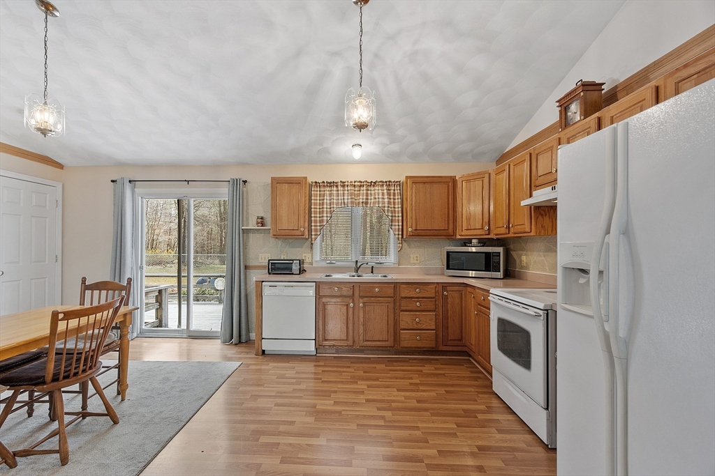 717 Old Petersham Road Barre, MA 01005 - Photo 7 of 40 a kitchen with stainless steel appliances granite countertop a stove top oven a refrigerator a sink and chairs