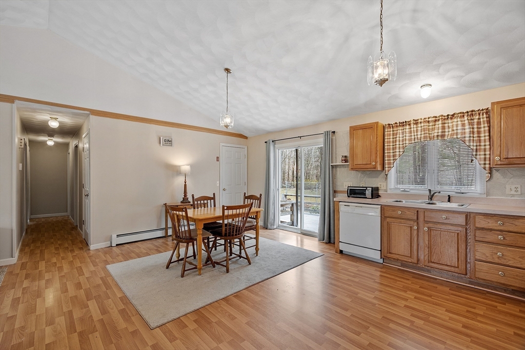 717 Old Petersham Road Barre, MA 01005 - Photo 8 of 40 a view of a dining room and livingroom with furniture wooden floor a chandelier
