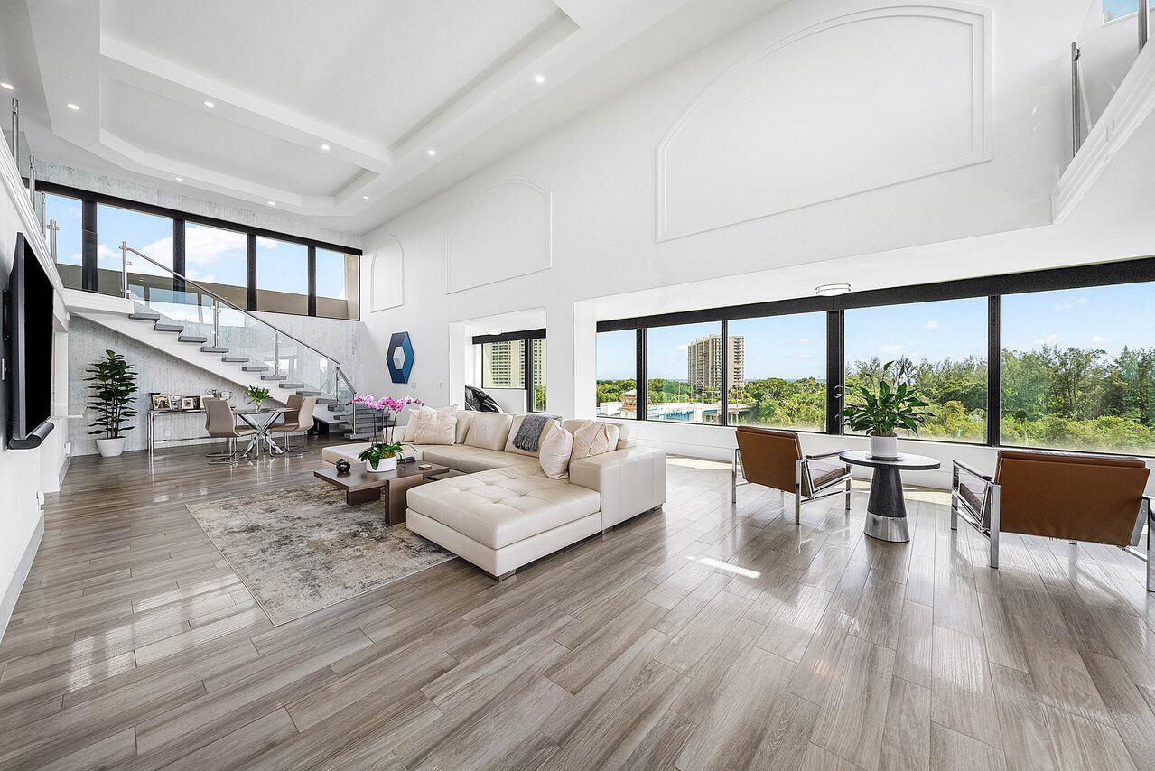 900 Northeast Spanish River Boulevard, Unit 7E Boca Raton, FL 33431 - Photo 12 of 71 a living room with furniture large window and wooden floor