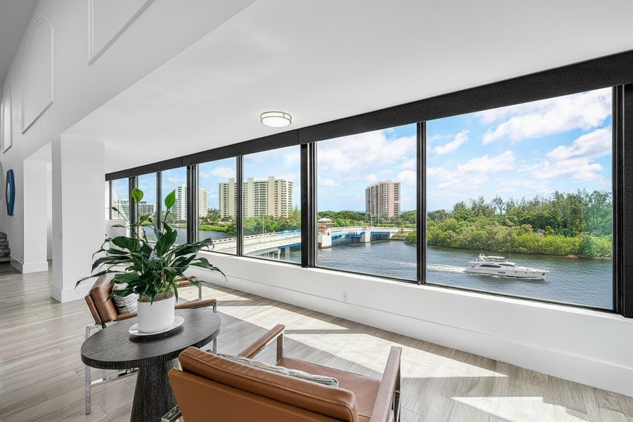 900 Northeast Spanish River Boulevard, Unit 7E Boca Raton, FL 33431 - Photo 14 of 71 a room with large windows and wooden floor