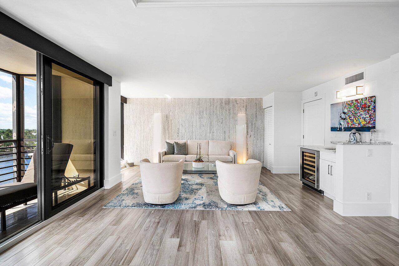 900 Northeast Spanish River Boulevard, Unit 7E Boca Raton, FL 33431 - Photo 17 of 71 a living room with furniture and a flat screen tv