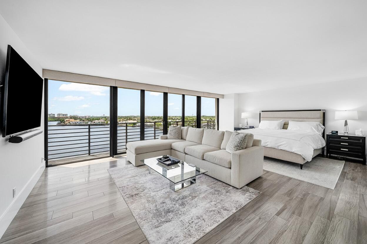 900 Northeast Spanish River Boulevard, Unit 7E Boca Raton, FL 33431 - Photo 30 of 71 a living room with furniture and a flat screen tv