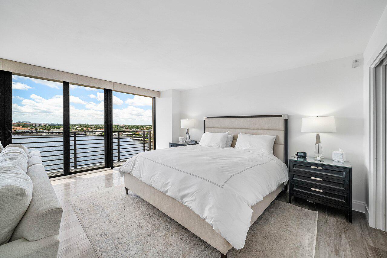 900 Northeast Spanish River Boulevard, Unit 7E Boca Raton, FL 33431 - Photo 36 of 71 a bedroom with a bed and a large window