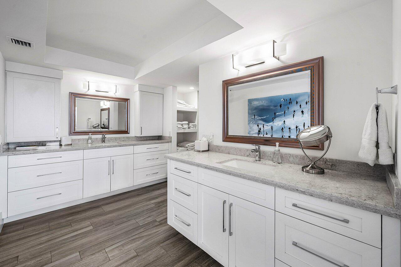 900 Northeast Spanish River Boulevard, Unit 7E Boca Raton, FL 33431 - Photo 38 of 71 a spacious bathroom with double vanity white cabinets and a wooden floor