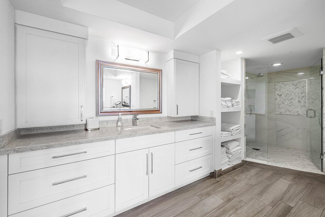 900 Northeast Spanish River Boulevard, Unit 7E Boca Raton, FL 33431 - Photo 39 of 71 a bathroom with a granite countertop sink mirror and double