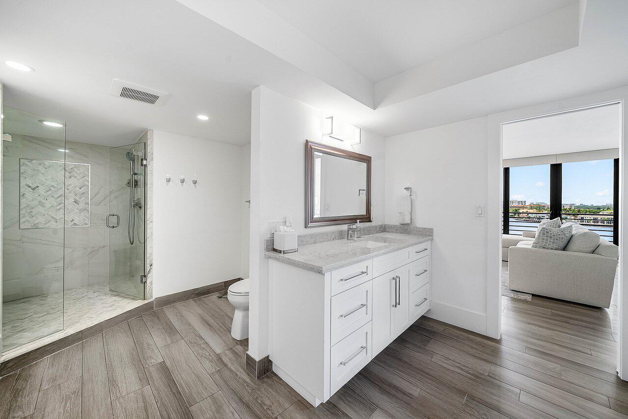 900 Northeast Spanish River Boulevard, Unit 7E Boca Raton, FL 33431 - Photo 40 of 71 a bathroom with a granite countertop double vanity sink and mirror