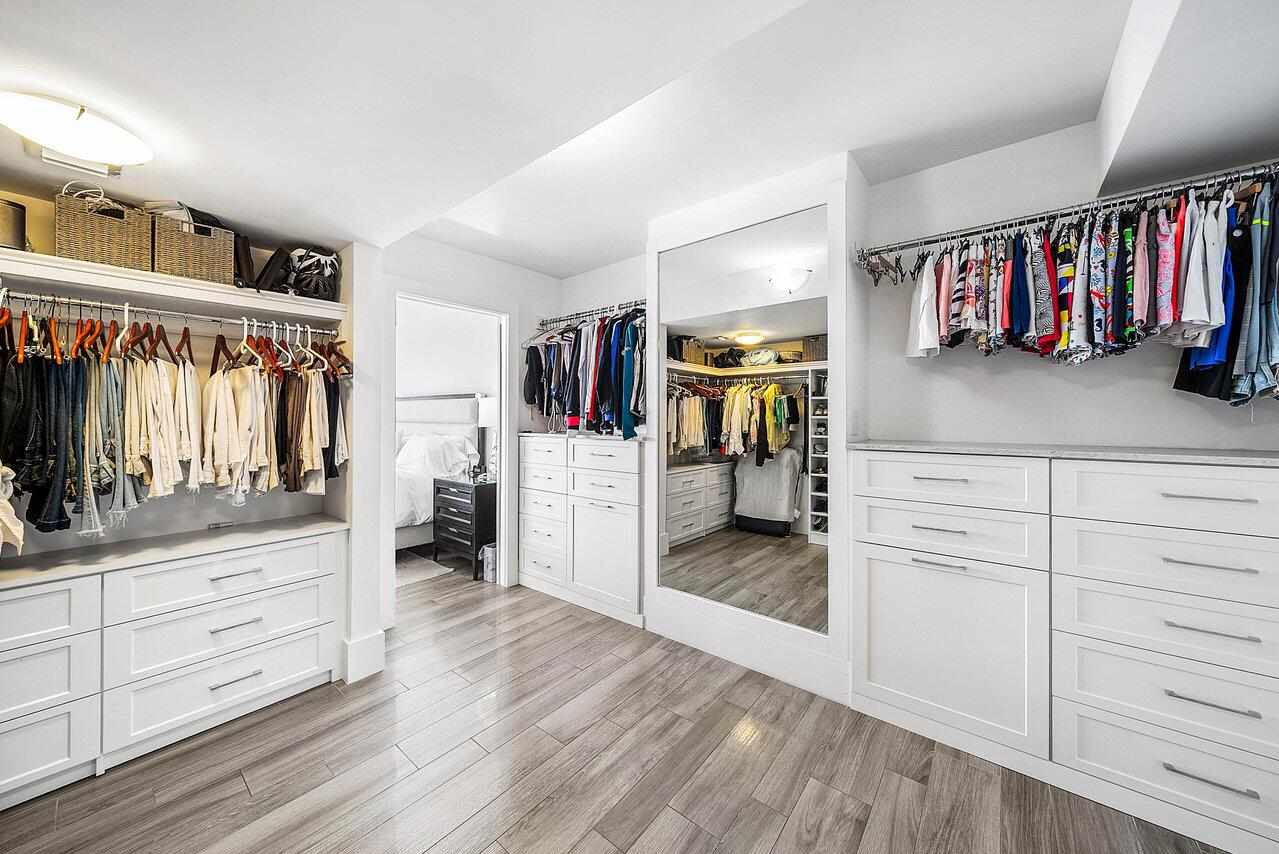 900 Northeast Spanish River Boulevard, Unit 7E Boca Raton, FL 33431 - Photo 41 of 71 a view of walk in closet with clothes and shoes