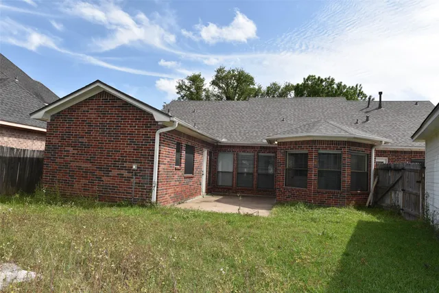 a front view of a house with a yard and outdoor seating