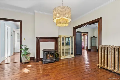 a view of a livingroom with wooden floor and a fireplace