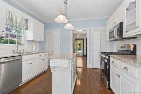 a kitchen with a sink stove and refrigerator