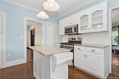a kitchen with stainless steel appliances granite countertop a stove and a sink
