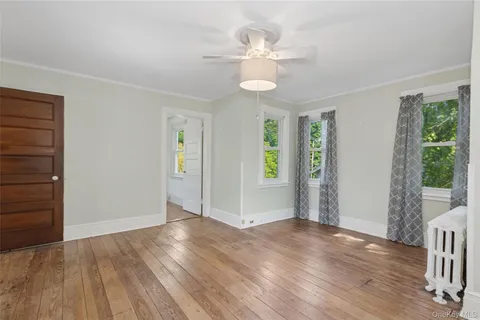 wooden floor in an empty room with a window