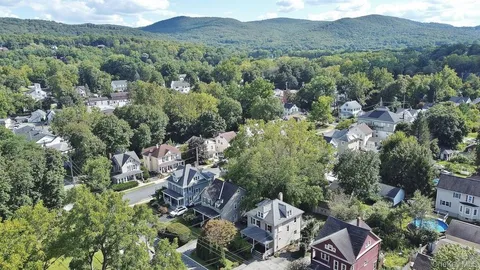 an aerial view of residential house with green space