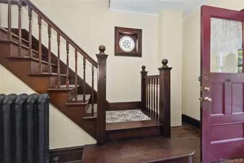 a view of entryway with stairs and wooden floor