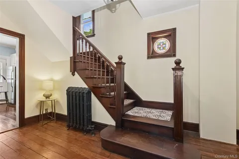 a view of entryway and hall with wooden floor