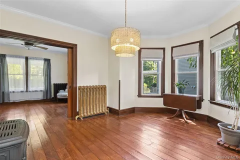 a room with wooden floor and windows