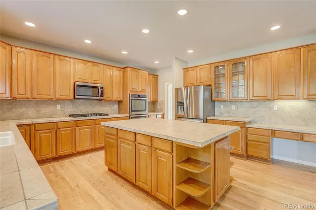 a kitchen with stainless steel appliances granite countertop a sink and cabinets