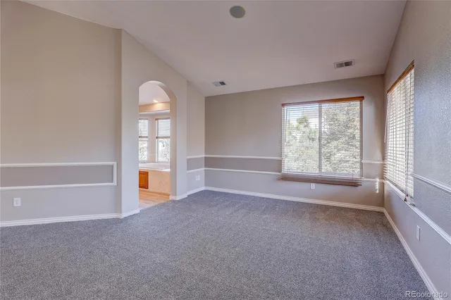 a spacious bathroom with a large tub and sink